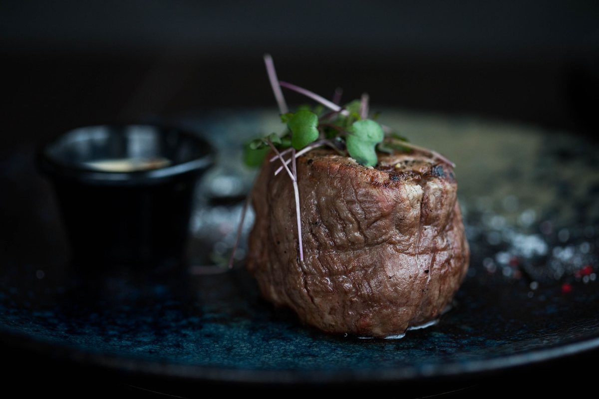 A plated dish in a dark dining room